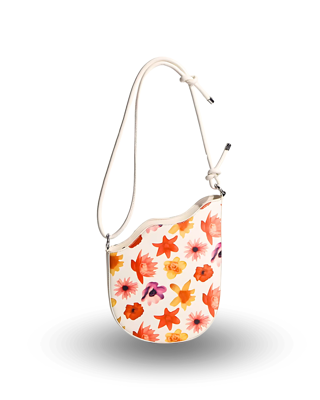 White shoulder bag with colorful floral print in orange, yellow, pink, and purple, featuring a curved top edge and adjustable strap with knotted detail