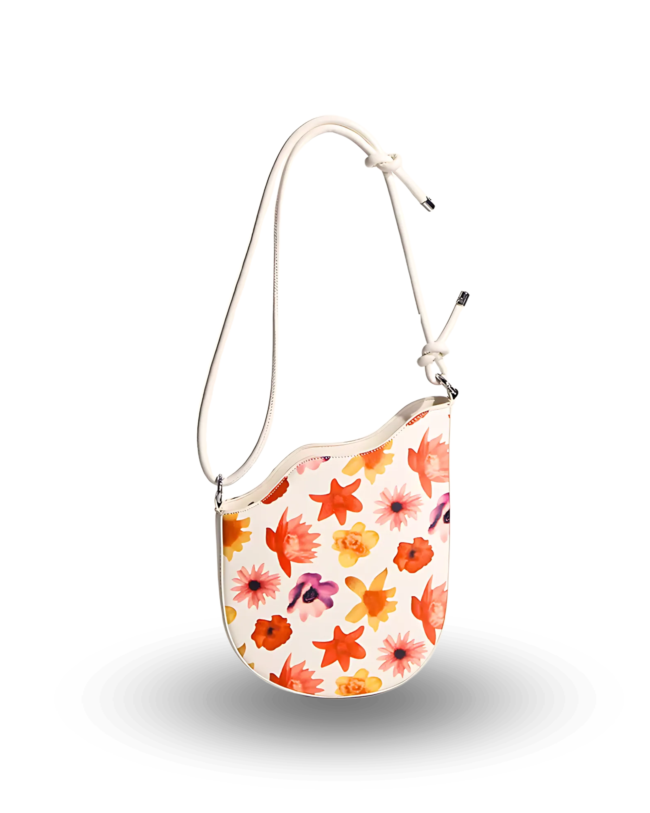White shoulder bag with colorful floral print in orange, yellow, pink, and purple, featuring a curved top edge and adjustable strap with knotted detail