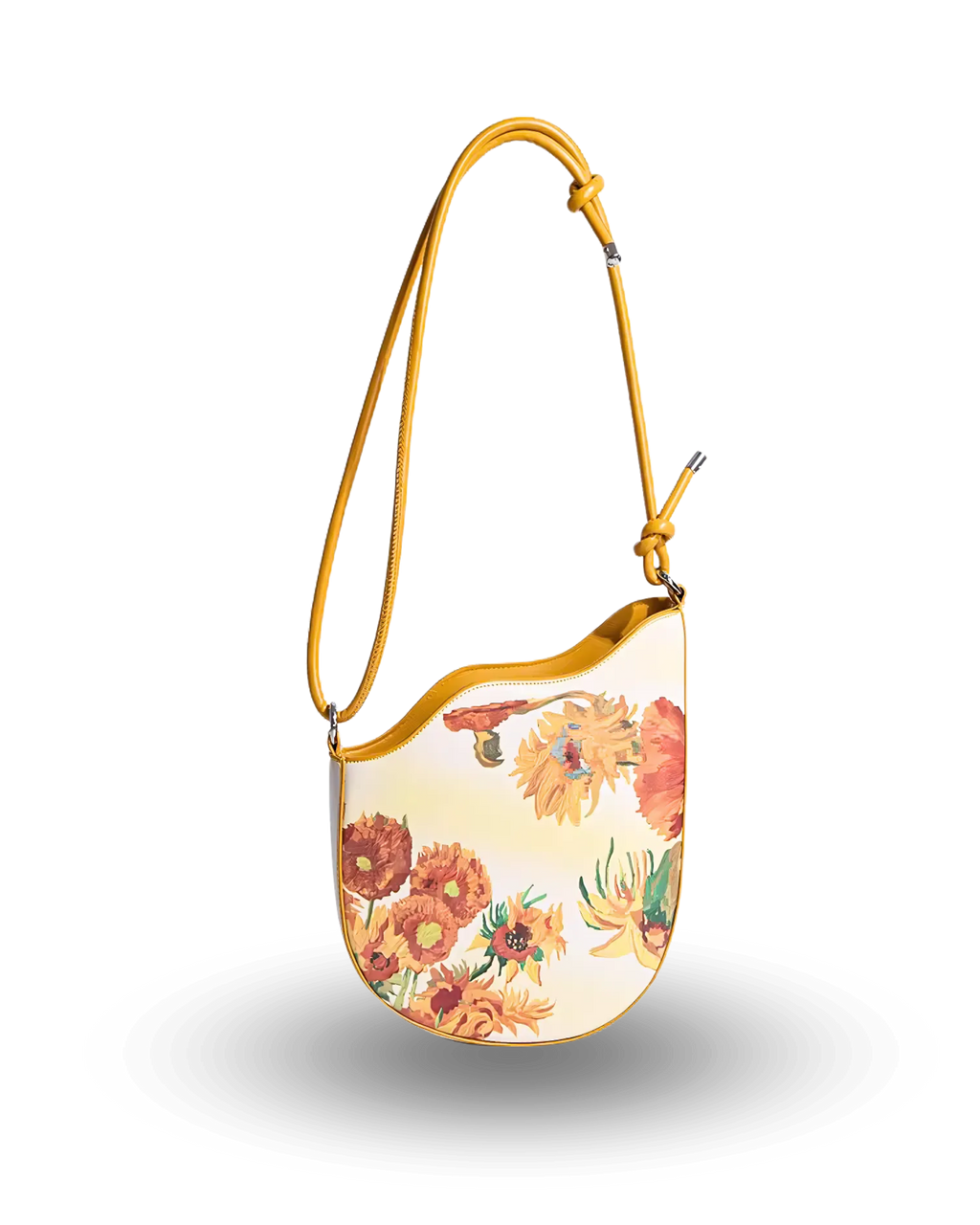 Cream shoulder bag with vibrant sunflower print, curved top edge, and adjustable mustard-yellow strap with knotted detail.