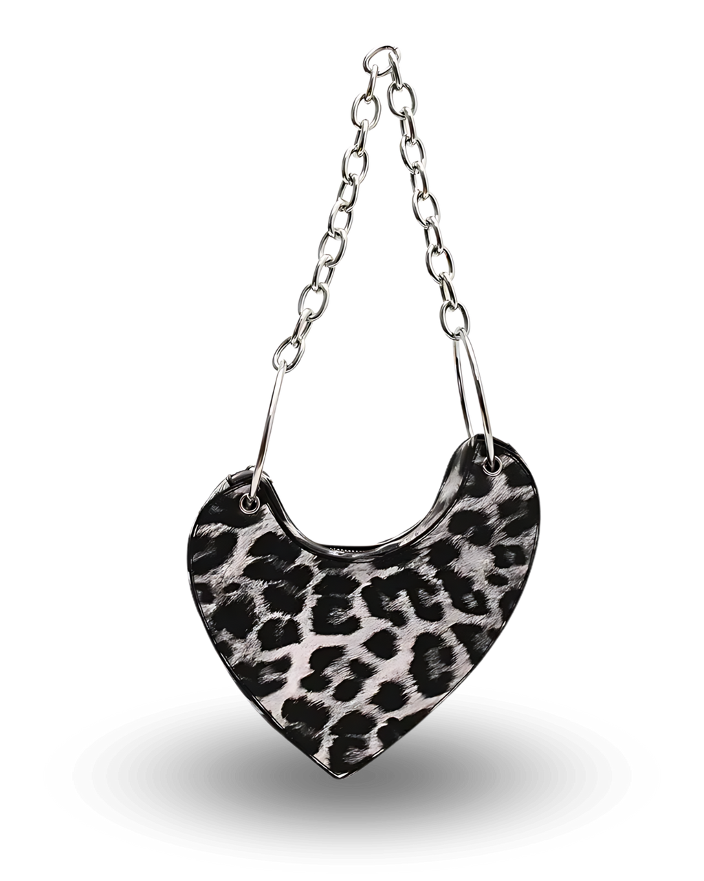 Black and white leopard print heart-shaped handbag with chunky silver chain strap, asymmetrical saddle design, and bold edgy style perfect for night outs or statement fashion looks.