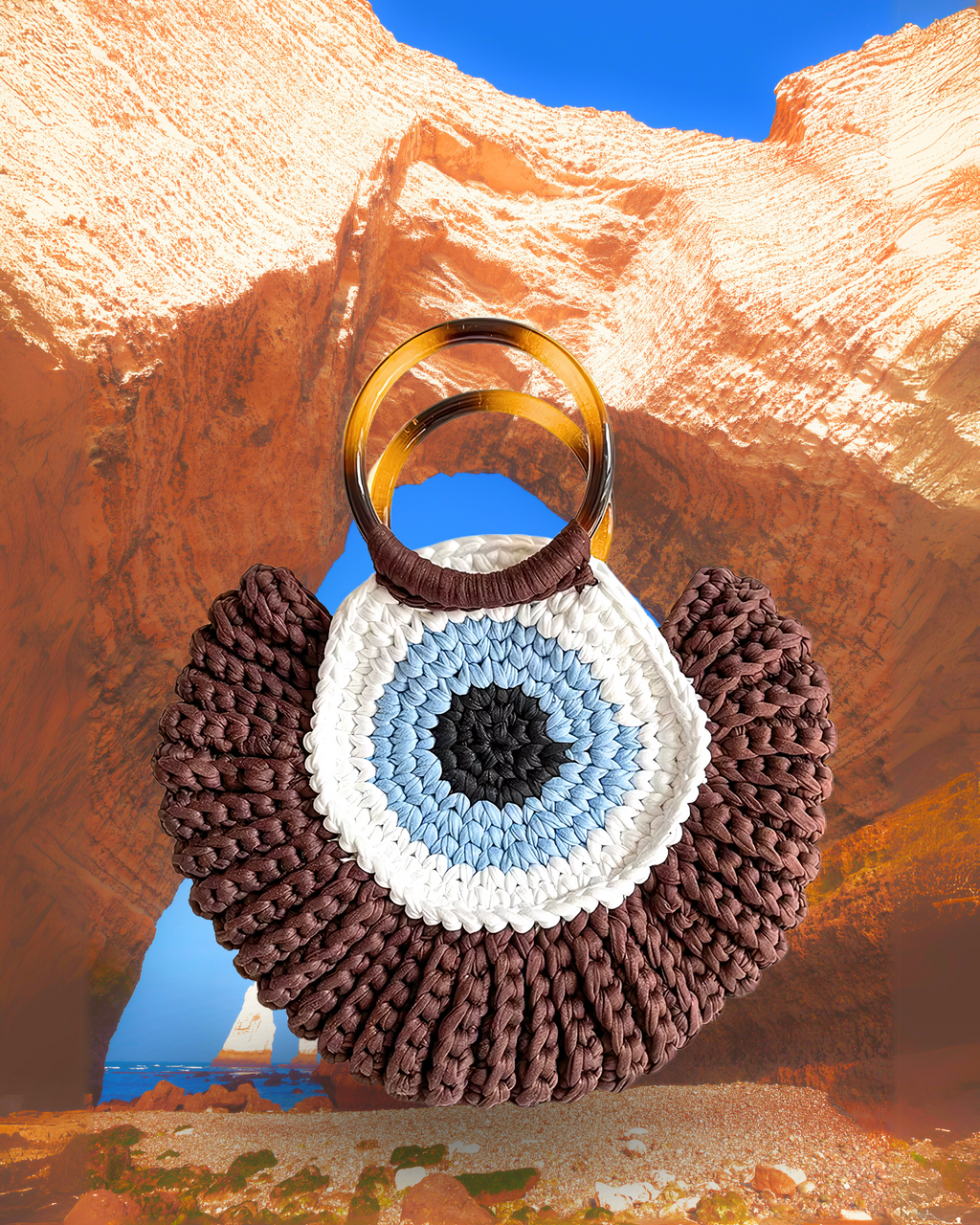 Round woven crochet handbag with layered fan-shaped black edges, evil eye design, and dual circular resin handles. brown color eye