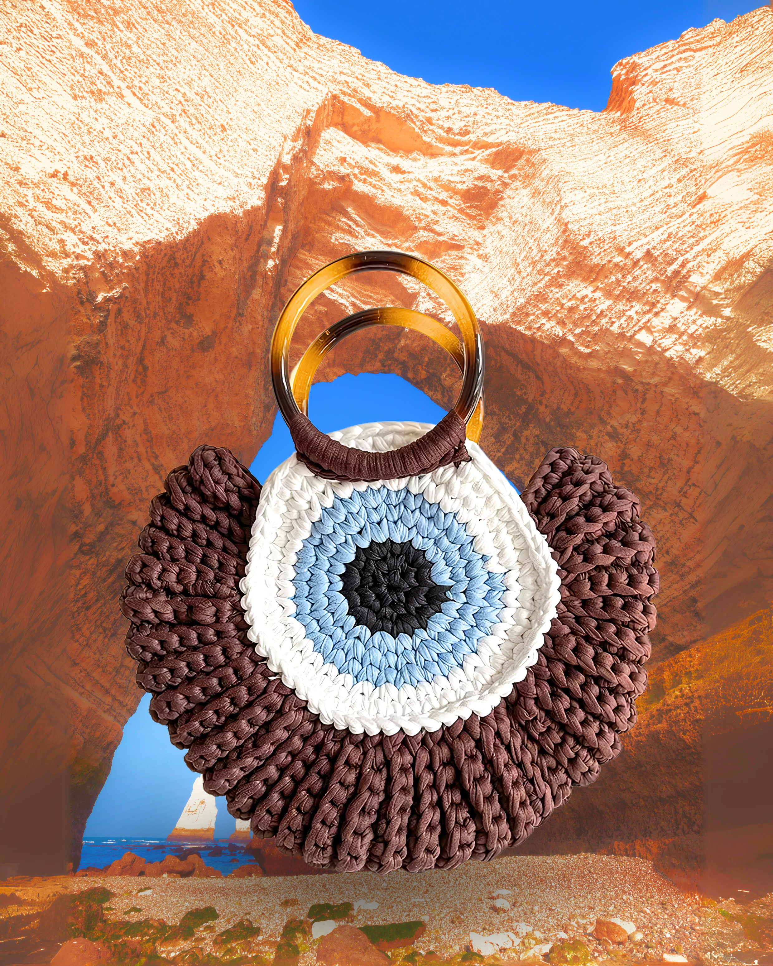 Round woven crochet handbag with layered fan-shaped black edges, evil eye design, and dual circular resin handles. brown color eye