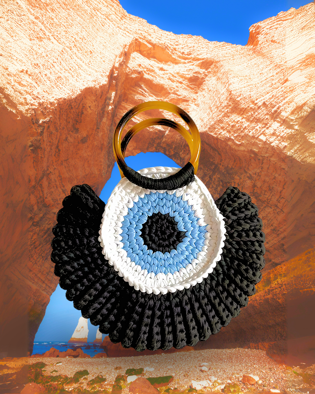 Round woven crochet handbag with layered fan-shaped black edges, evil eye design, and dual circular resin handles. Black color eye