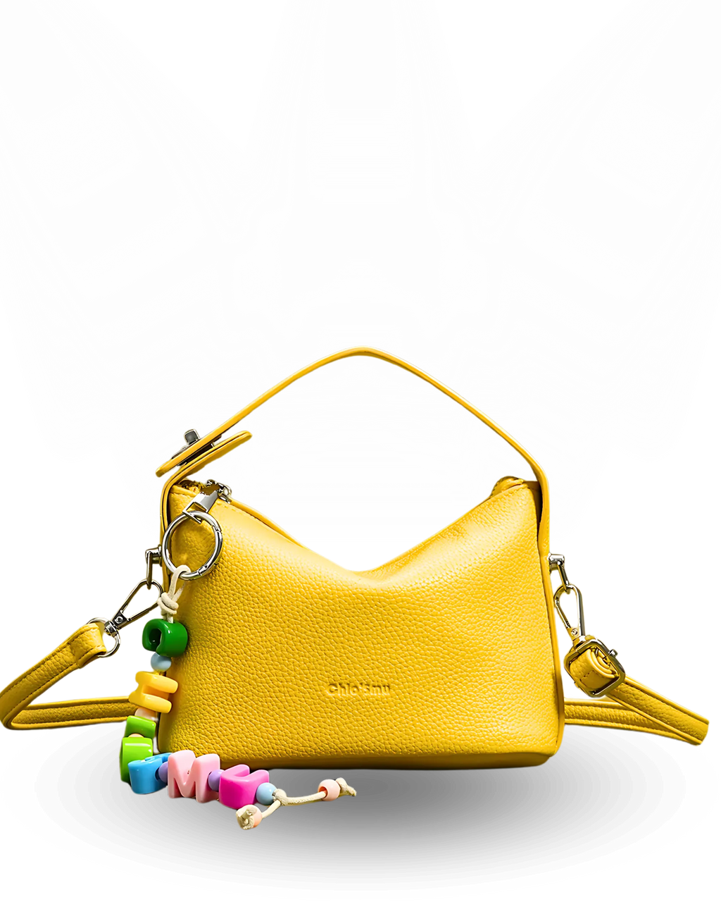 Yellow handbag with colorful keychain on a white background