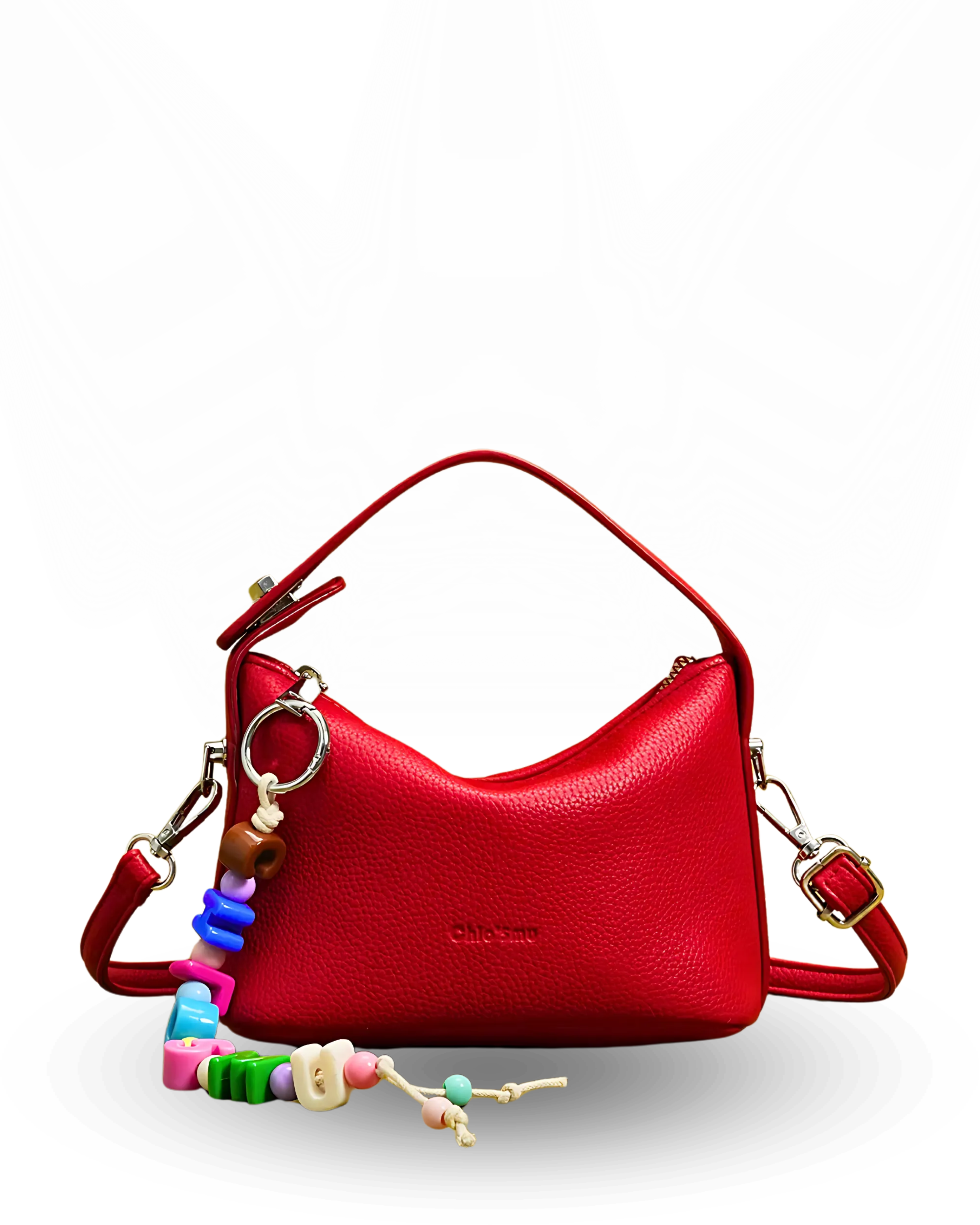 Red handbag with a colorful keychain on a white background