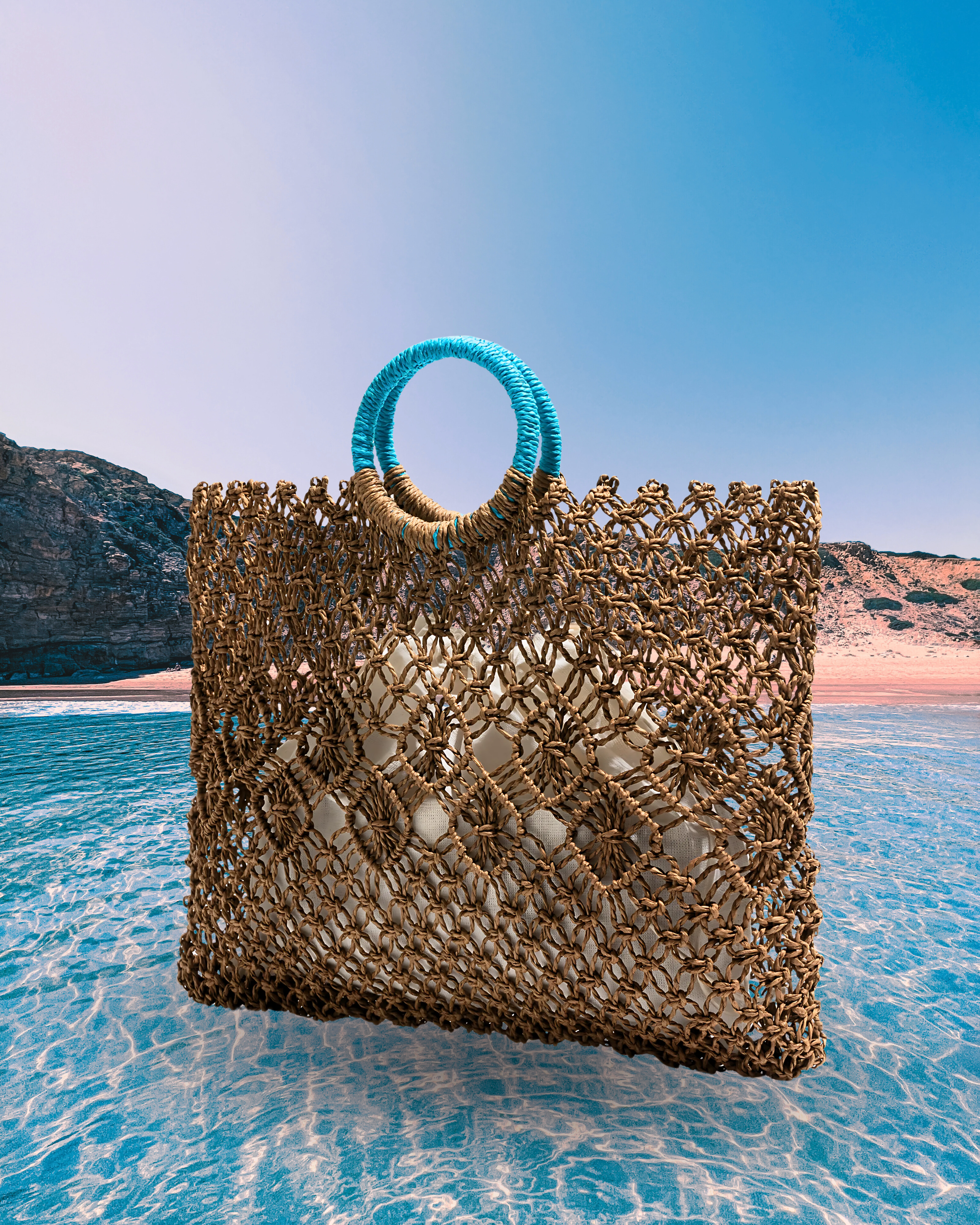 Rectangular woven straw net tote bag with diamond-patterned open weave, round turquoise-wrapped handles, and an inner fabric pouch