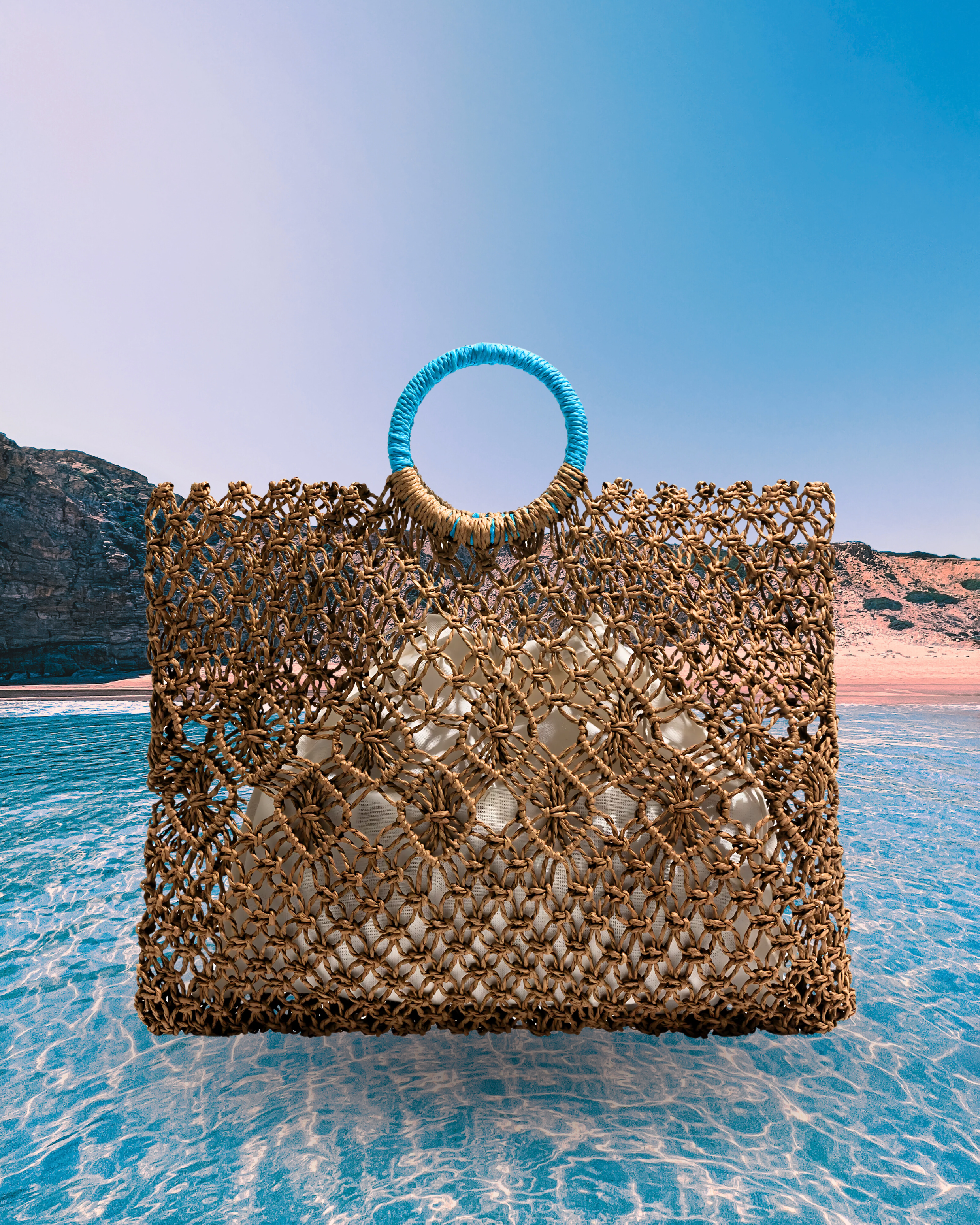 Rectangular woven straw net tote bag with diamond-patterned open weave, round turquoise-wrapped handles, and an inner fabric pouch