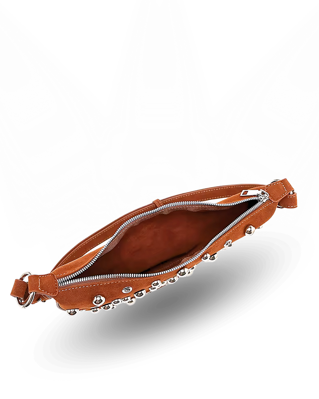 Curved crossbody sling bag made form vegan suede in autumn tan colours with a top zipper closure, adjustable shoulder strap, and metallic studded accents across the front.
