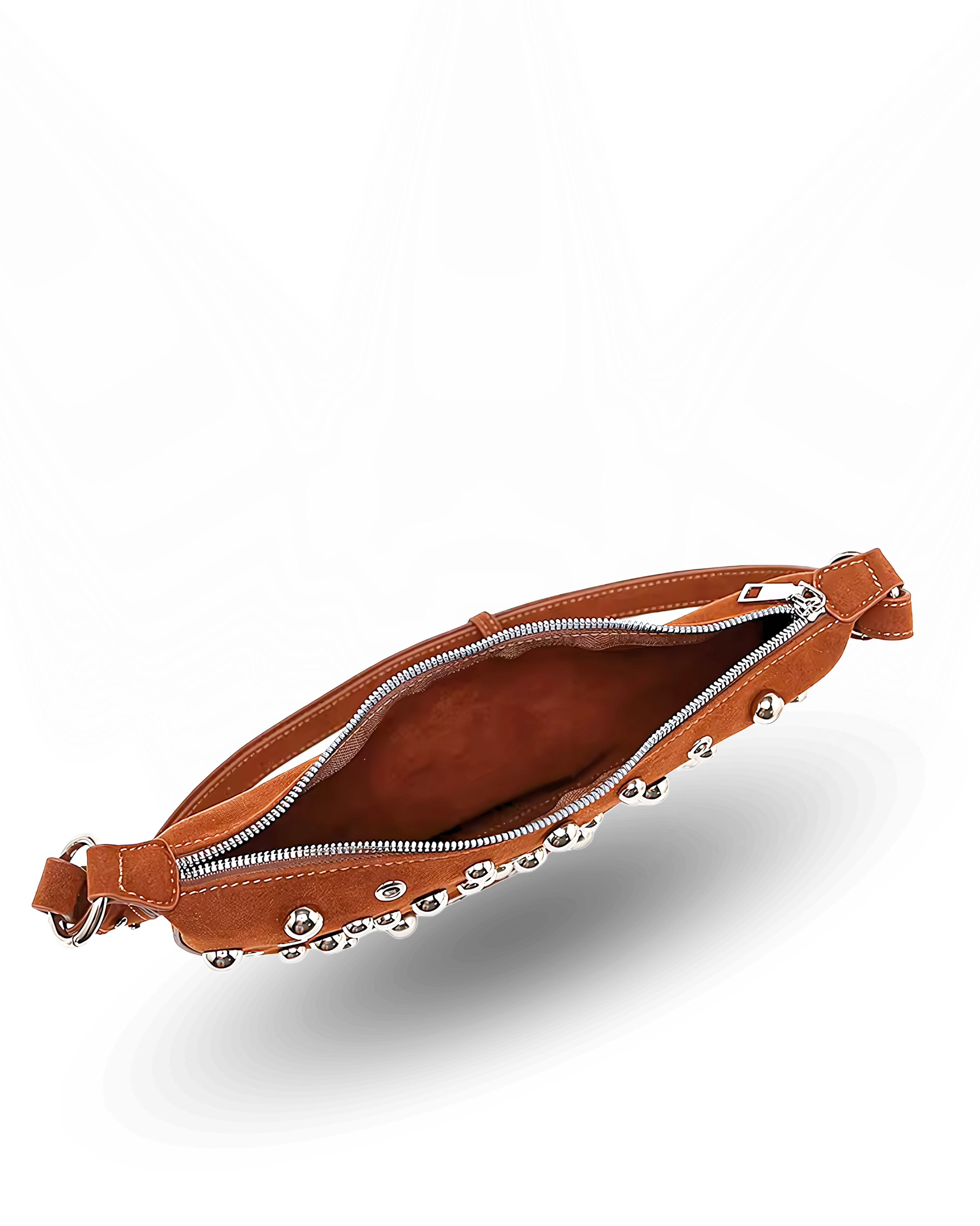 Curved crossbody sling bag made form vegan suede in autumn tan colours with a top zipper closure, adjustable shoulder strap, and metallic studded accents across the front.