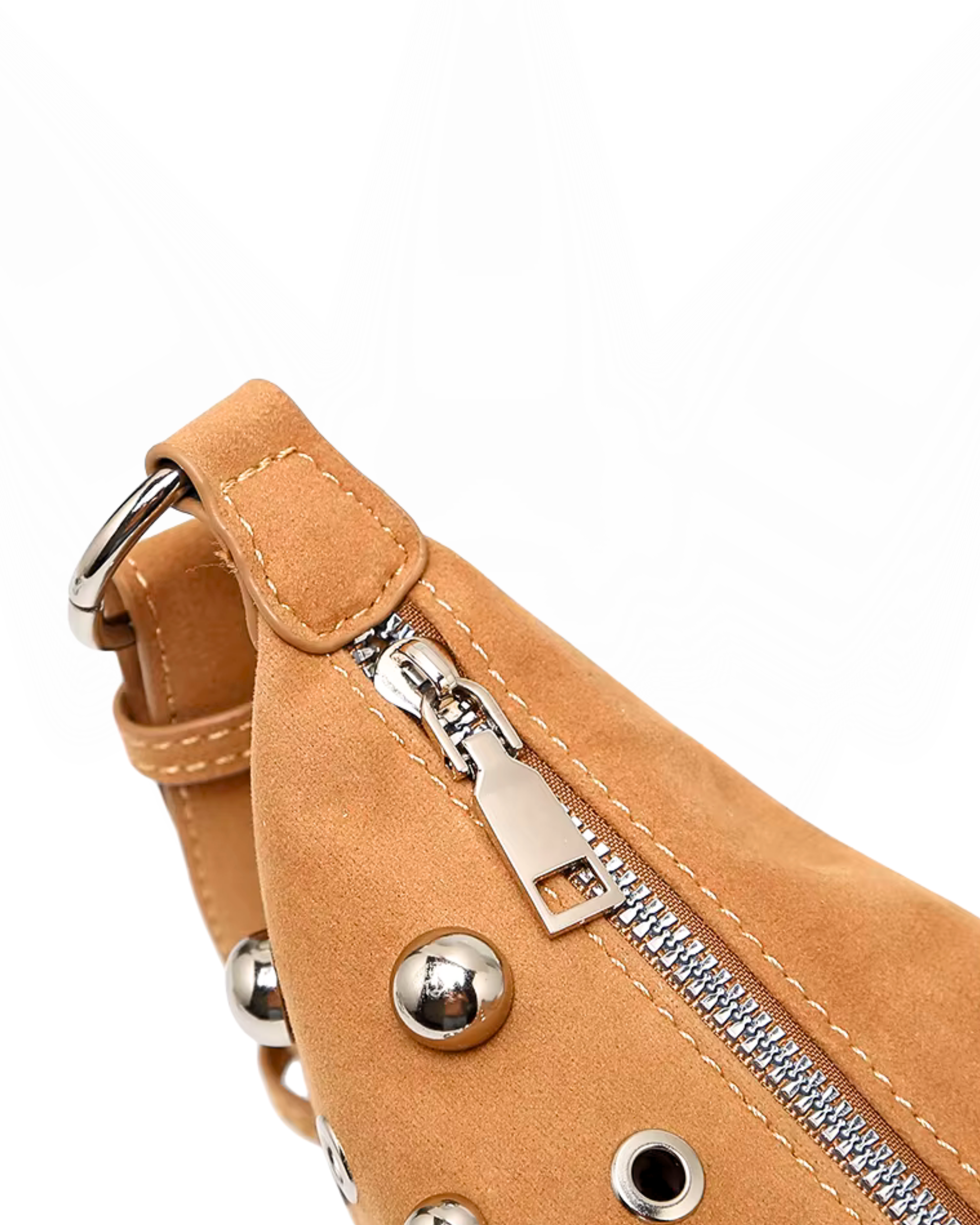 Curved crossbody sling bag made form vegan suede in autumn tan colours with a top zipper closure, adjustable shoulder strap, and metallic studded accents across the front