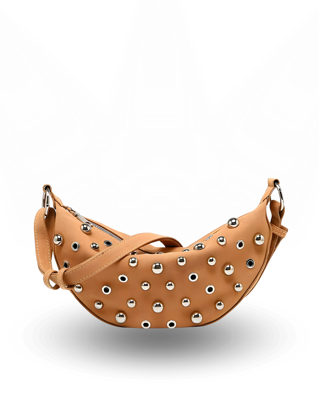 Curved crossbody sling bag made form vegan suede in autumn tan colours with a top zipper closure, adjustable shoulder strap, and metallic studded accents across the front