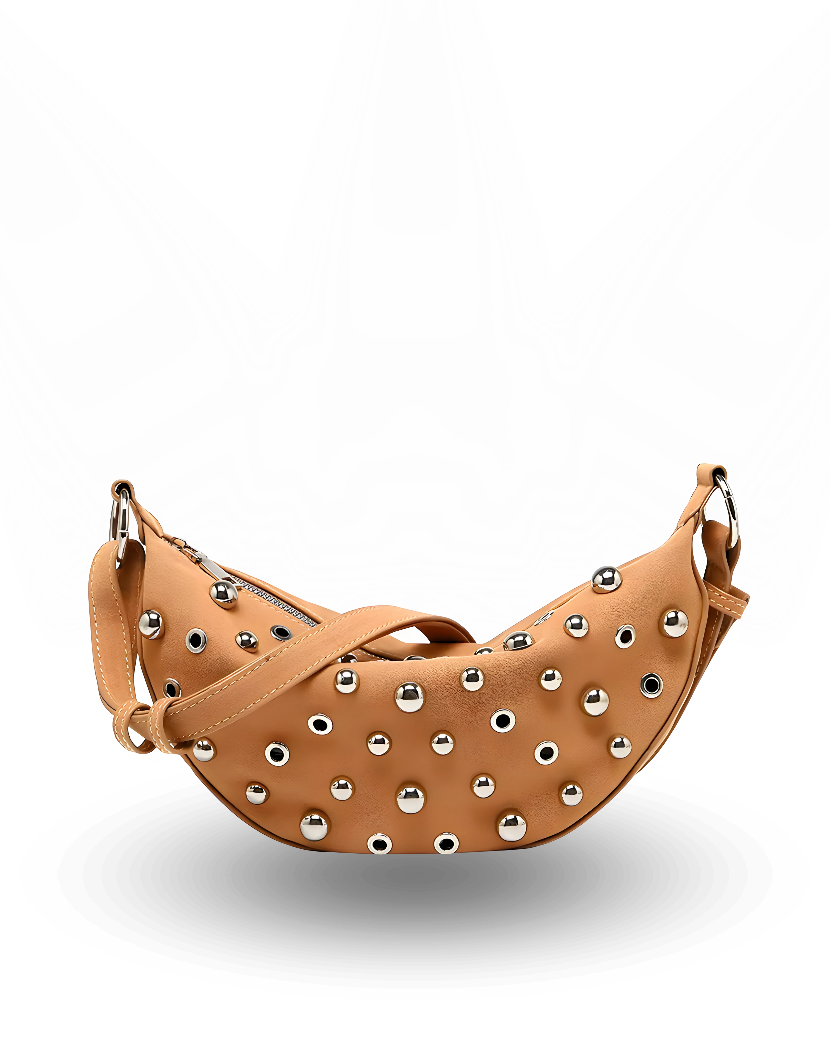 Curved crossbody sling bag made form vegan suede in autumn tan colours with a top zipper closure, adjustable shoulder strap, and metallic studded accents across the front