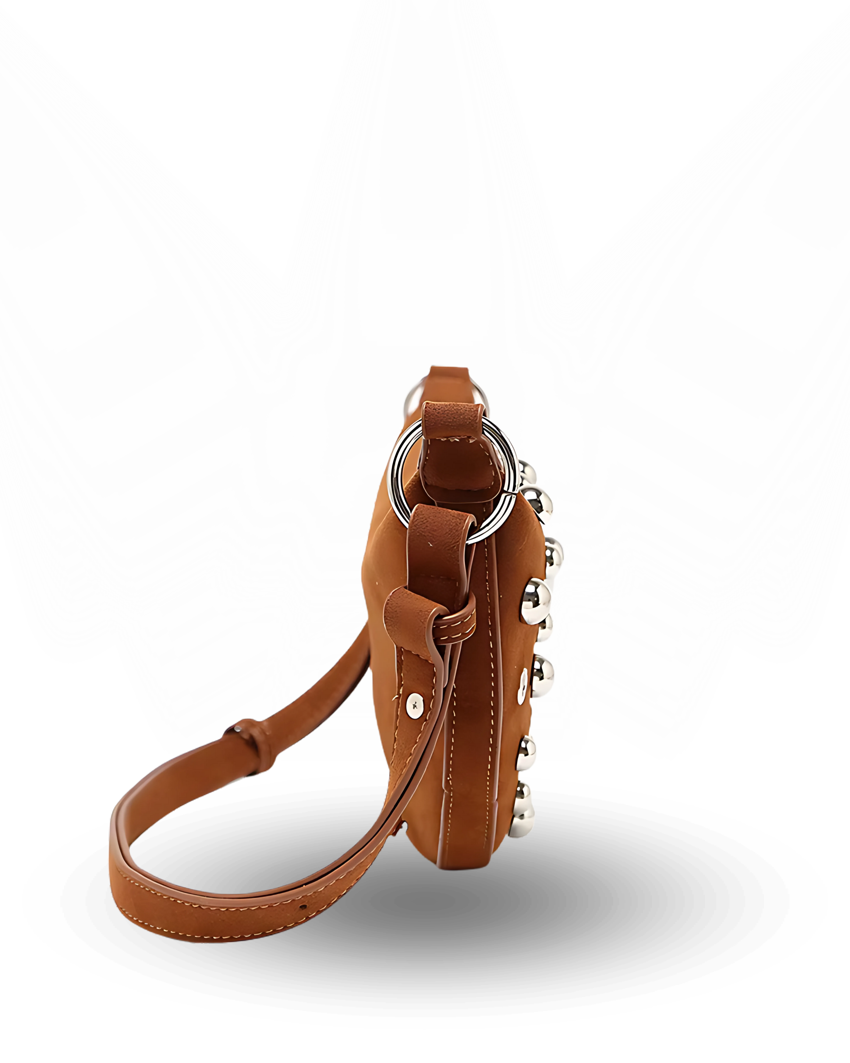 Curved crossbody sling bag made form vegan suede in autumn tan colours with a top zipper closure, adjustable shoulder strap, and metallic studded accents across the front.