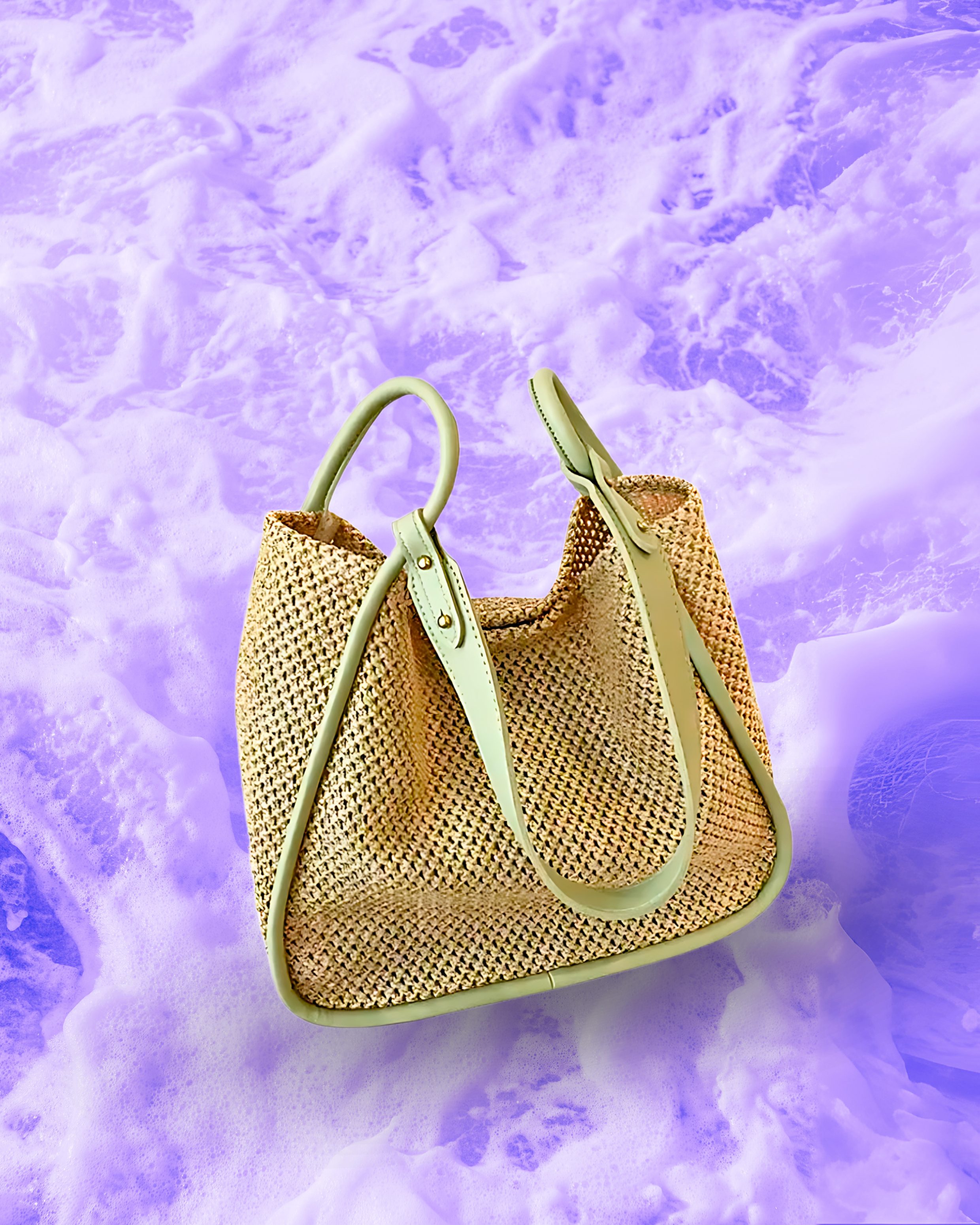 Soft rectangular woven raffia shoulder bag with a slouchy open-top design, long adjustable muted green leatherette strap, and muted green contrast trim framing the edges.
