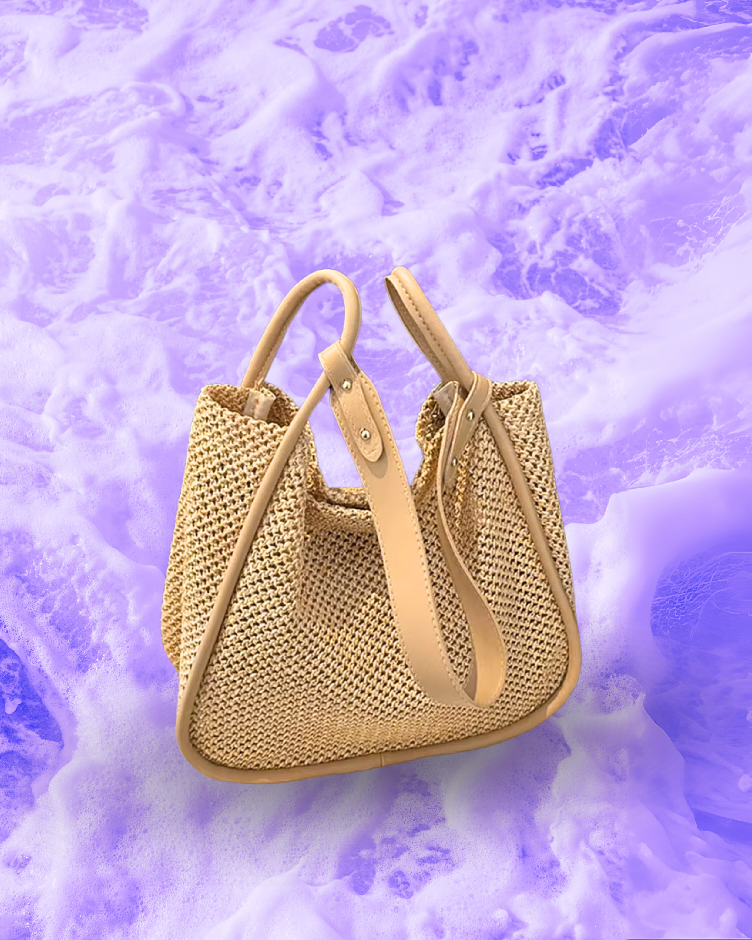 Soft rectangular woven raffia shoulder bag with a slouchy open-top design, long adjustable nude leatherette strap, and nude contrast trim framing the edges.