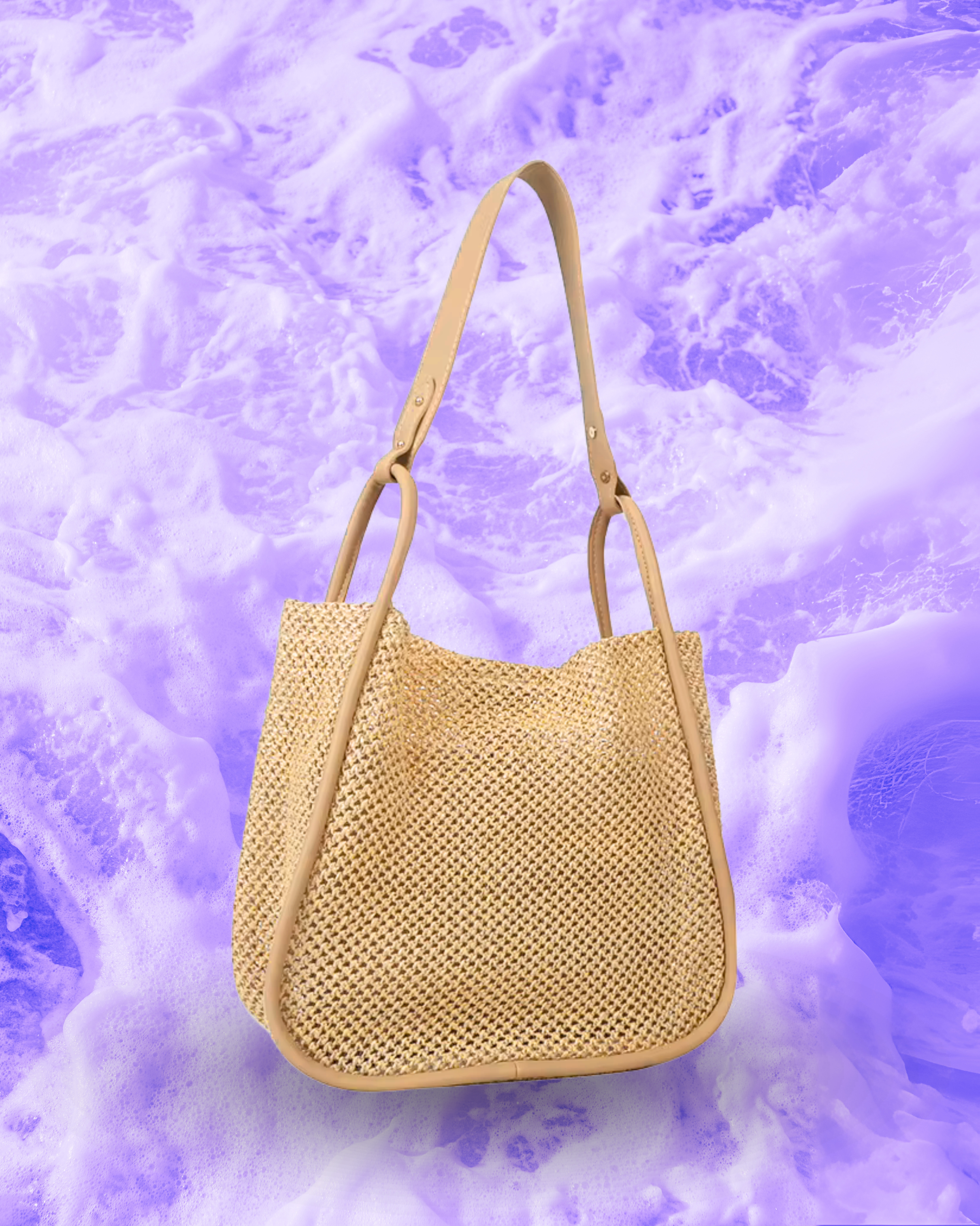 Soft rectangular woven raffia shoulder bag with a slouchy open-top design, long adjustable nude leatherette strap, and nude contrast trim framing the edges.