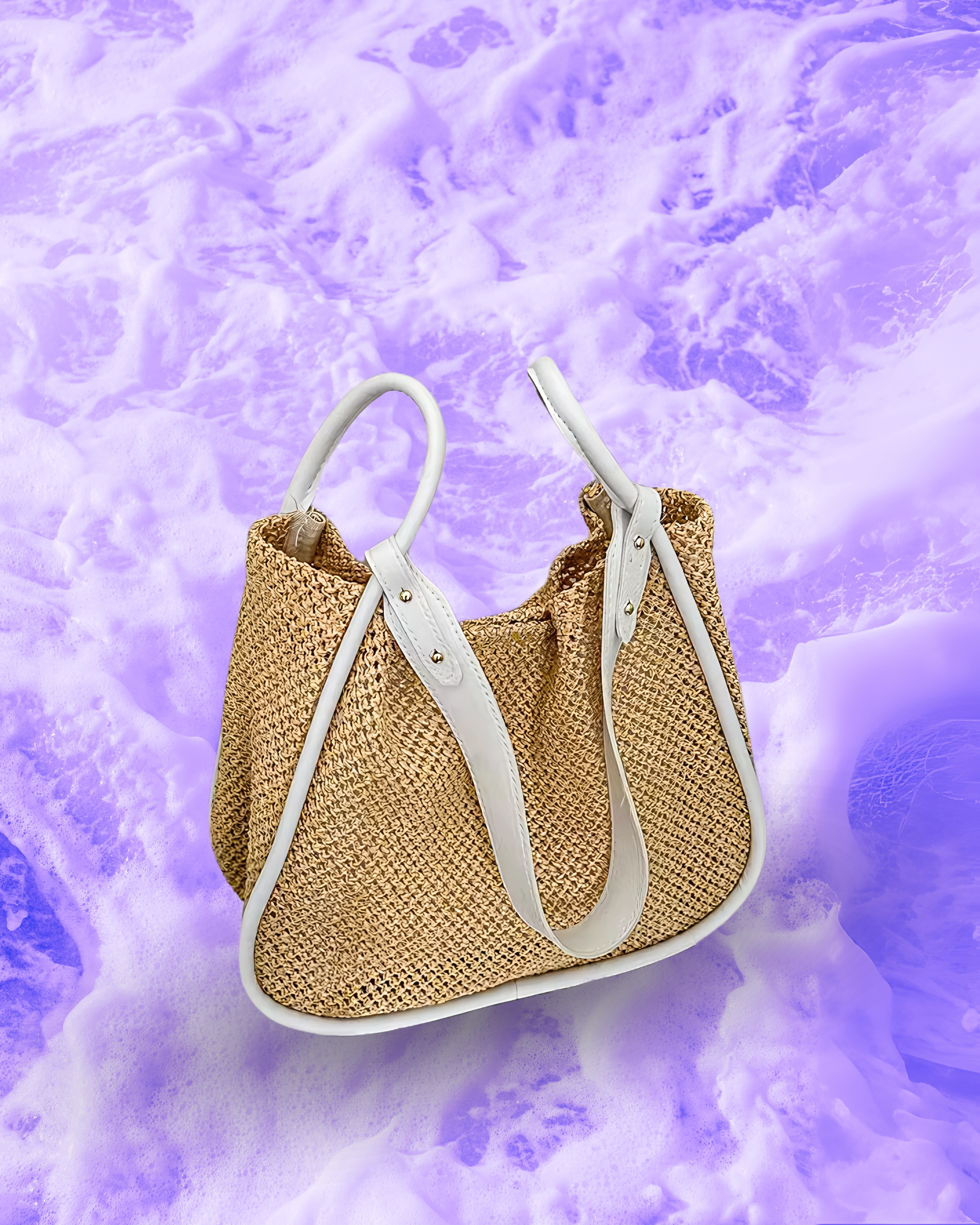 Soft rectangular woven raffia shoulder bag with a slouchy open-top design, long adjustable white leatherette strap, and white contrast trim framing the edges.