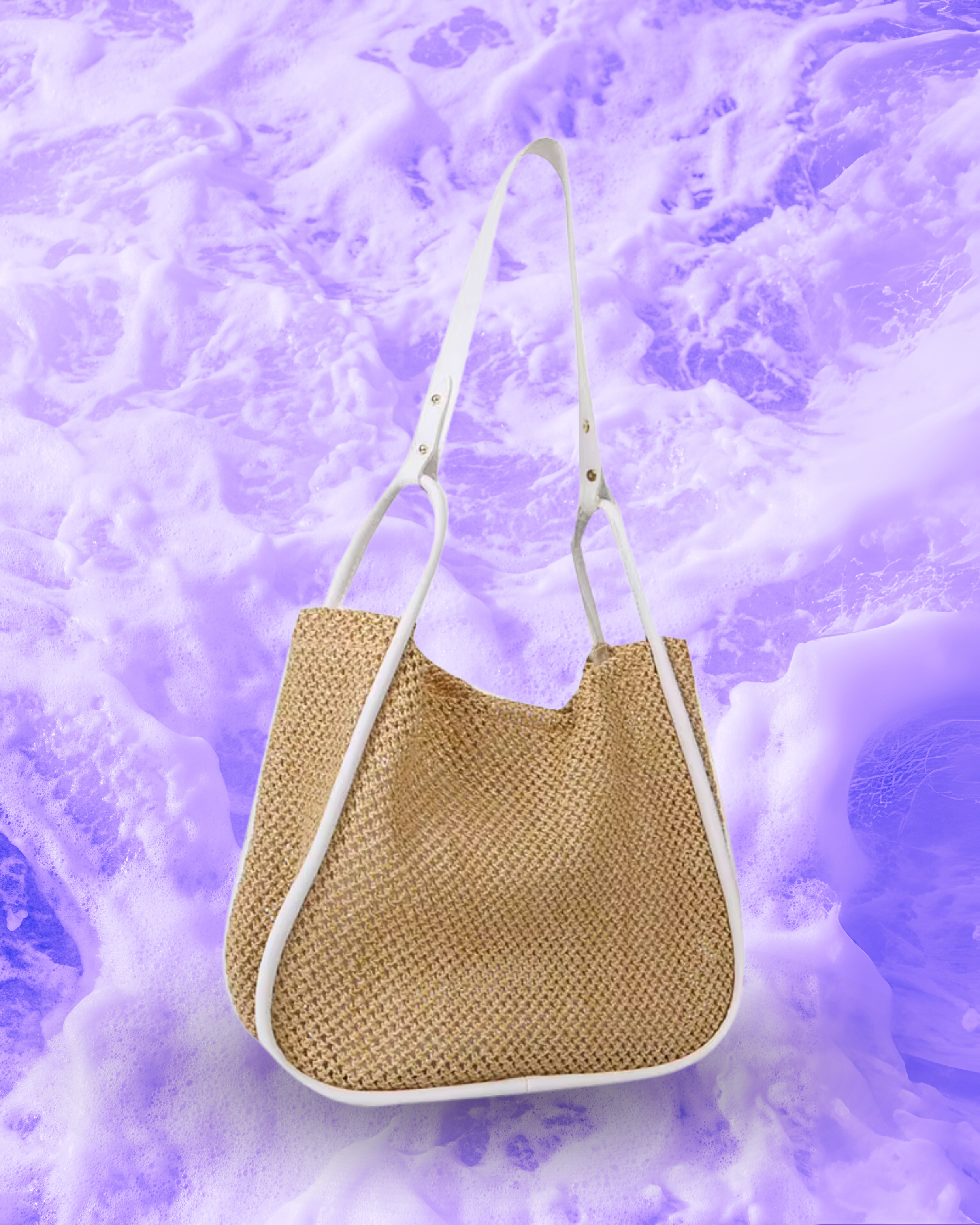 Soft rectangular woven raffia shoulder bag with a slouchy open-top design, long adjustable white leatherette strap, and white contrast trim framing the edges.