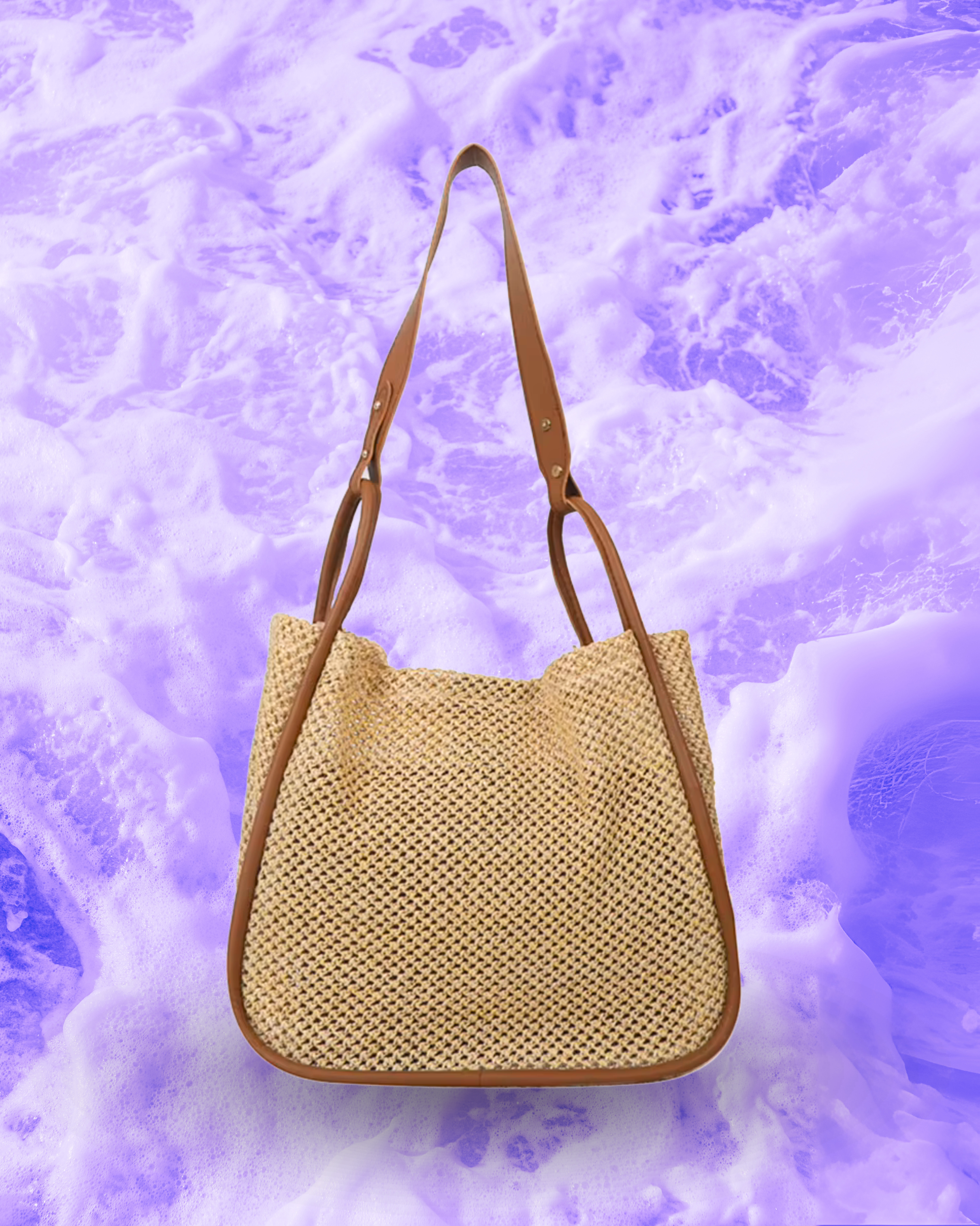 Soft rectangular woven raffia shoulder bag with a slouchy open-top design, long adjustable brown leatherette strap, and brown contrast trim framing the edges.