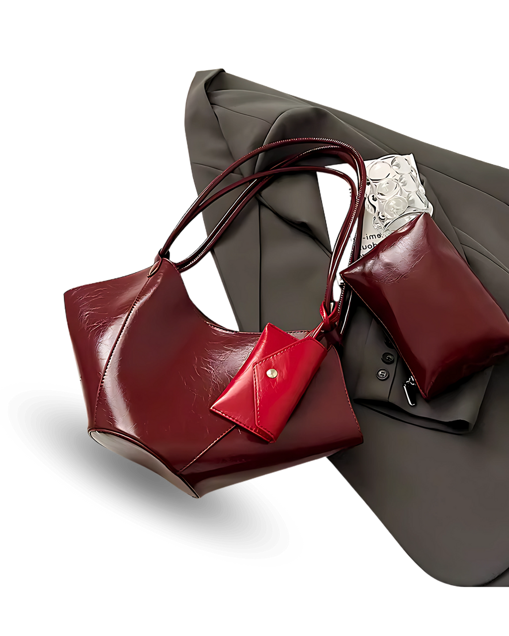 Unique deep red vegan leather handbag with sculpted, winged sides, dual shoulder straps, and a matching pouch accessory