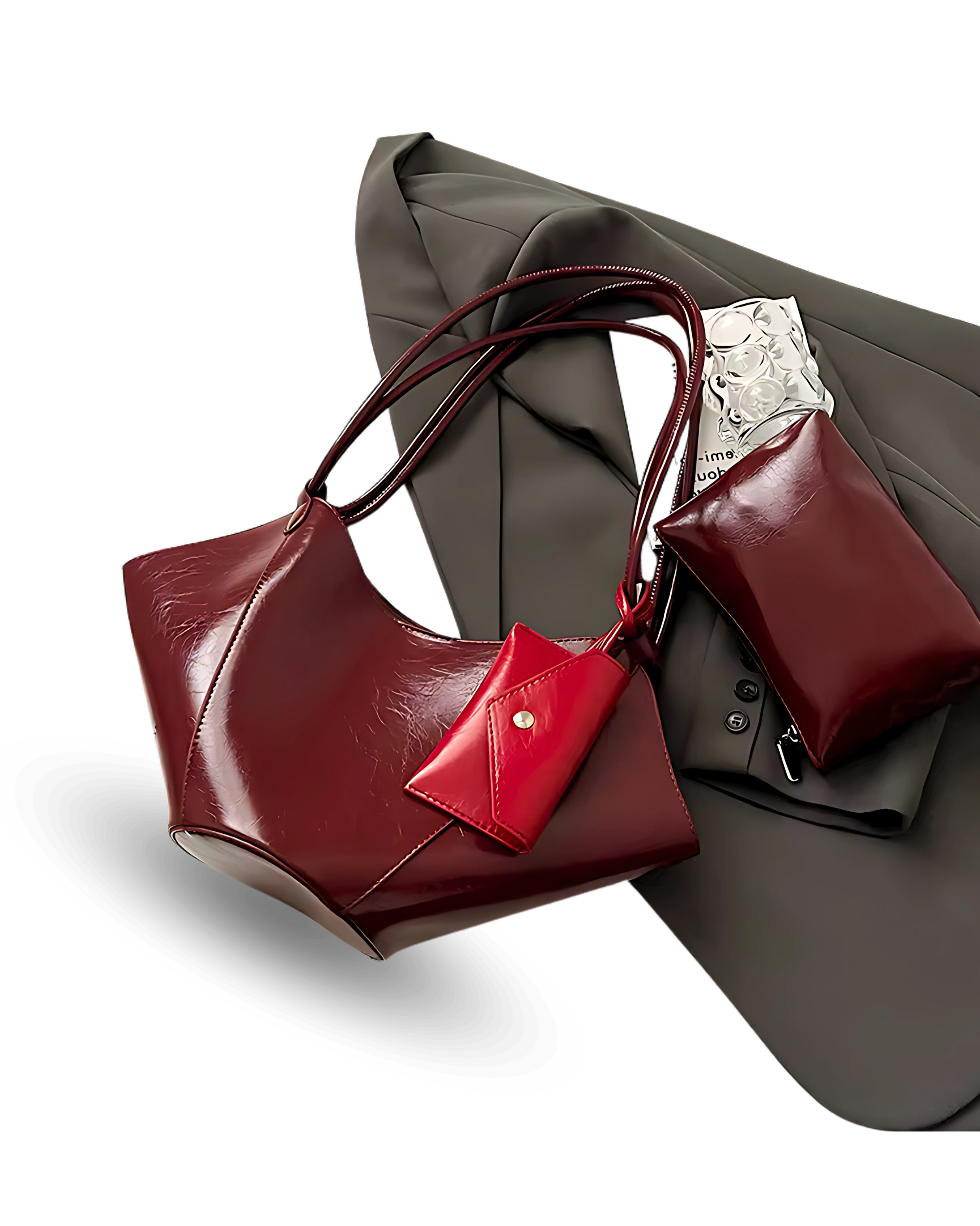 Unique deep red vegan leather handbag with sculpted, winged sides, dual shoulder straps, and a matching pouch accessory