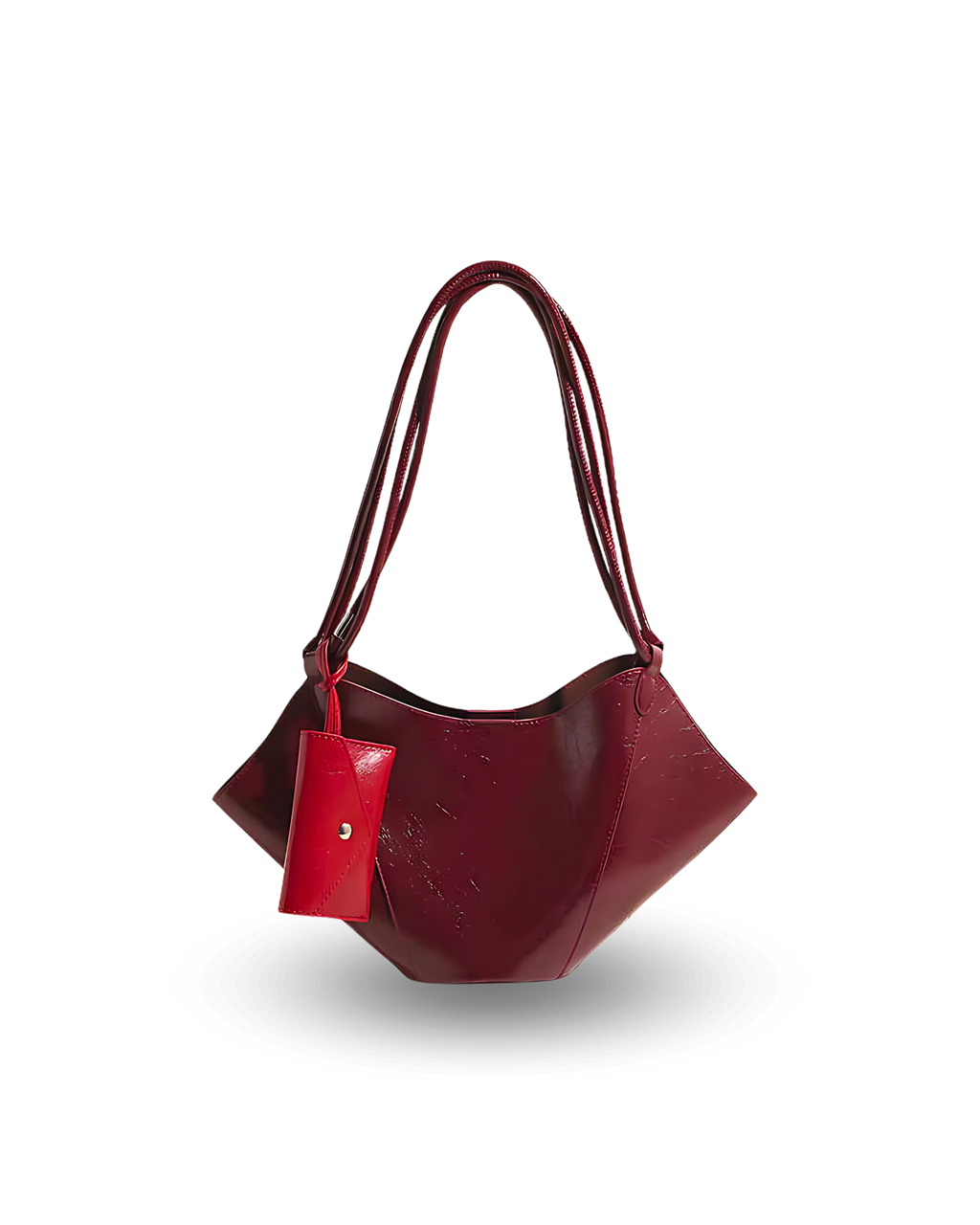 Unique deep red vegan leather handbag with sculpted, winged sides, dual shoulder straps, and a matching pouch accessory